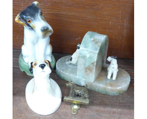 A fox terrier wall plaque, a fox terrier lamp base, a wire haired fox terrier door knocker and a pair of onyx bookends with p