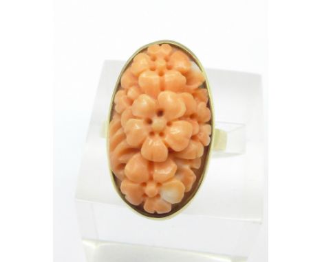 A 9ct gold and carved coral ring, 10.3g, R, 24mm x 13mm