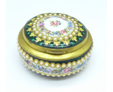 A circular, gilt and enamel decorated trinket box, lacking two enamel 'pearls'