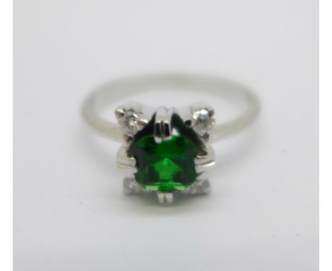 A white metal, diamond and green stone ring, tests as 18ct gold, with continental control marks, 3g, L