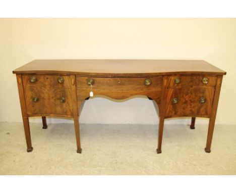 A GEORGIAN REVIVAL MAHOGANY SIDEBOARD, c.1900, of serpentine form, with stringing and shell paterae, central frieze drawer ov