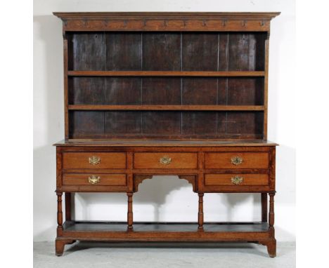 A VICTORIAN OAK DRESSER, the boarded delft rack with moulded cornice over two shelves, the pot board base with moulded top ed