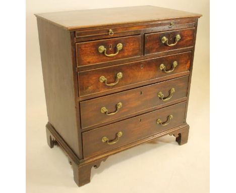 A SMALL MAHOGANY CHEST, 18th century, the moulded edged top over baize lined slide, two short and three long cockbeaded drawe