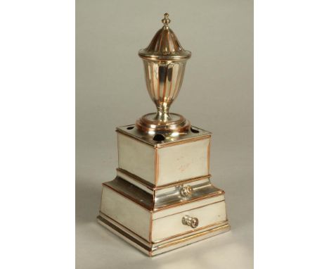 A PLATED ON COPPER DESK STANDISH, c.1800, the panelled urn taperstick with lift off cover, swivelling on a square stand with 