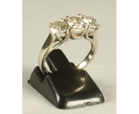 A THREE STONE DIAMOND RING, the brilliant cut stones each of approximately 0.5cts claw set to a plain 14ct gold shank, size K