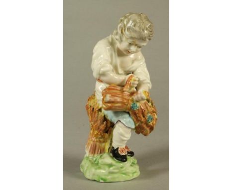 A DERBY PORCELAIN FIGURE, c.1770, allegorical of Autumn modelled as a young boy wearing a white open neck shirt and blue bree