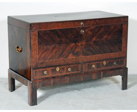 A GEORGE II OAK BLANKET CHEST ON STAND, mid 18th century, quarter veneered in rosewood with yew banding and stringing, brass 