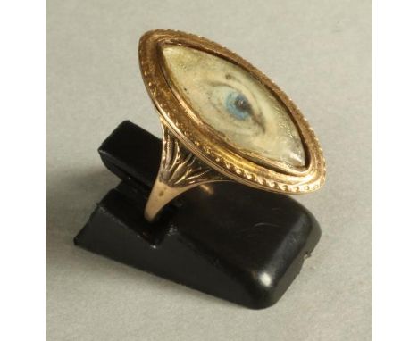 A GEORGIAN "EYE" RING, the eliptical ivory panel painted with a blue eye in a plain unmarked gold border and close back set t