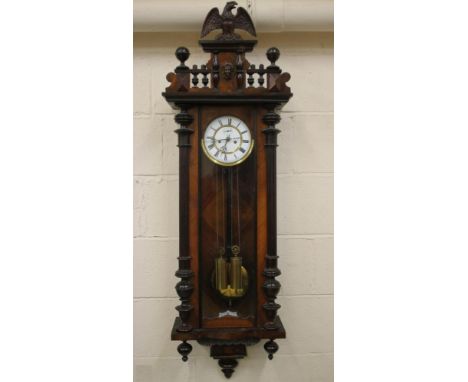 A WALNUT CASED VIENNA TYPE WALL CLOCK, the twin train weight driven movement with two piece white enamel dial and Roman numer