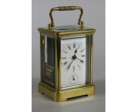 A BRASS CASED CARRIAGE CLOCK, the twin train movement with cylinder escapement striking on a bell, the white enamel dial with