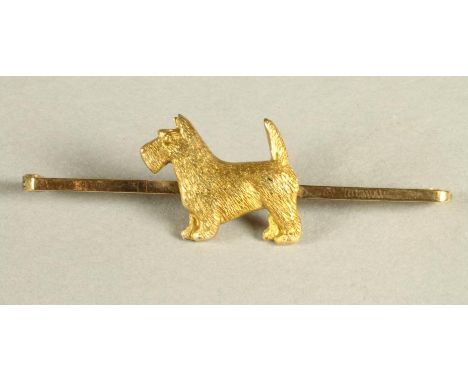 A 9CT GOLD TIE PIN centred by a terrier, 2.9g
