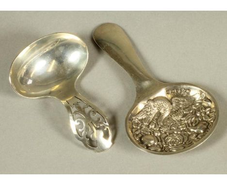 A SILVER CADDY SPOON, maker Henry Quickendon, Birmingham 1930, the oval bowl chased with a large bird flying over fruits and 