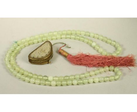 A SINGLE STRING OF JADE BEADS, the one hundred and six spherical beads on an unknotted green silk cord, 19 1/2" long, togethe