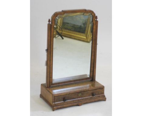 A GEORGIAN WALNUT AND FEATHER BANDED TOILET MIRROR, mid 18th century, the bevelled ogee arched plate within a moulded surroun