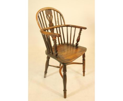 A YEW WINDSOR ARMCHAIR, early 19th century, of low hoop back form with shaped pierced splat, baluster turned arm supports, sa