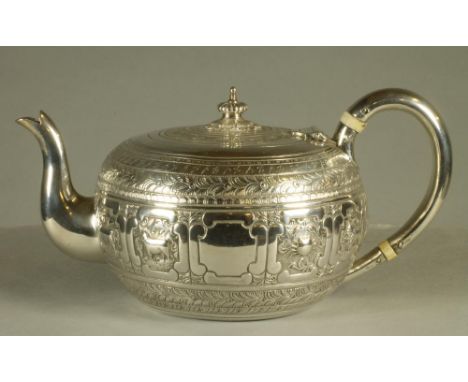 A VICTORIAN SILVER INDIANESQUE TEAPOT, maker George Fox, London 1877, of cushion form, the hinged cover with lobed knop, plai