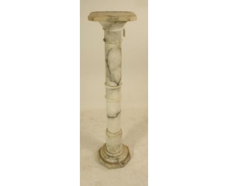 AN ALABASTER PEDESTAL, early 20th century, the canted square stand raised on stepped and ring turned column, on octagonal pli