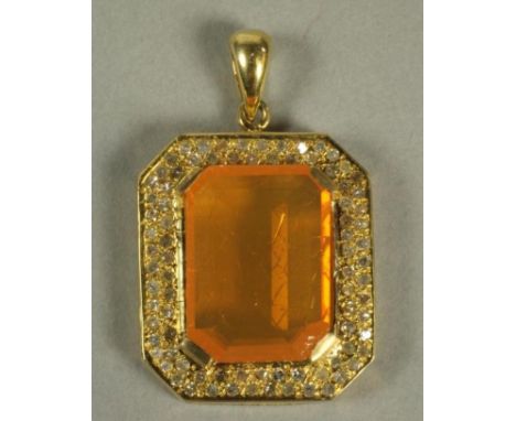 A FIRE OPAL PENDANT, the canted oblong cut stone set to an open deep border millegrain set with numerous small diamonds to an