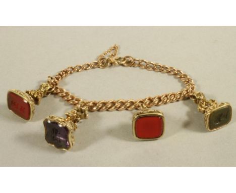 A 9CT GOLD HOLLOW CURB LINK CHAIN BRACELET, hung with four 19th century and later hardstone set seals including a bloodstone 