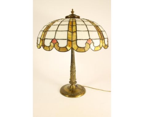 A GILT METAL ELECTRIC TABLE LAMP BASE, early 20th century, the tapering reeded column with stiff leaf and wave cast collar is