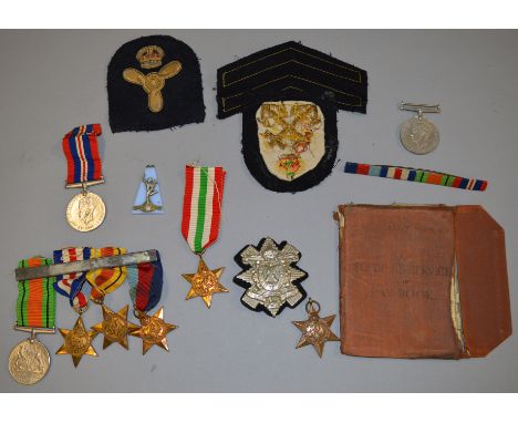 Collection of various medals and similar including a WW2 Army pay book, cap badges, ribbon bars etc.