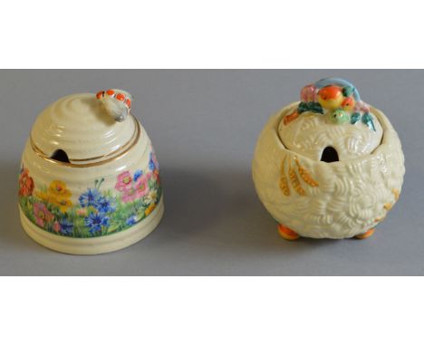 A Clarice Cliff "Harvest" jam pot together with a bee hive example (2)