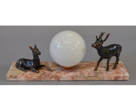 An Art Deco desk lamp set on a marble base flanked on either side by copper stag and doe figures. 40cm long.