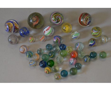 40+ vintage hand-made marbles, various sizes and patterns. Varying conditions.