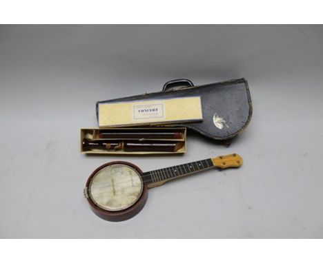 A 20TH CENTURY BANJO UKULELE, 20cm diameter x 54cm long, cased, together with a SCHOTT'S WOODEN CONCERT TENOR RECORDER, boxed