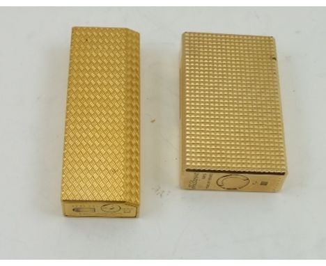 A "CARTIER" AND A "DUPONT" CIGARETTE LIGHTER, both in gilt metal textured effect finish (2) 