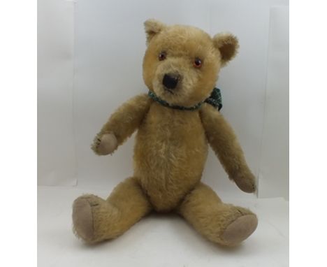 A 20TH CENTURY TEDDY BEAR, allover golden mohair, having stitched nose and paws, button eyes, and jointed limbs, 56cm high 