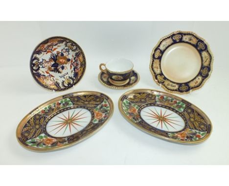 A ROYAL WORCESTER PORCELAIN TRIO, comprising tea cup, saucer and tea plate, in blush ivory and cobalt blue painted flowers an