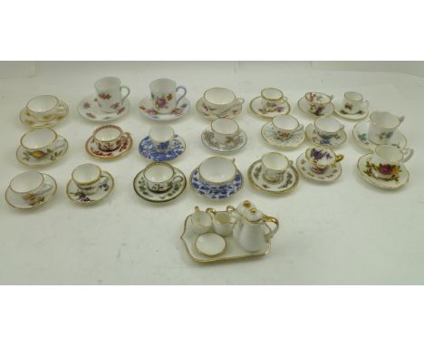 A COLLECTION OF MINIATURE CERAMIC CUPS AND SAUCERS, factories such as Shelley, Spode, Coalport, together with TWO OAK DISPLAY