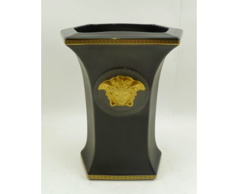 A ROSENTHAL VERSACE CERAMIC VASE, of waisted hexagonal form, black ground, with Greek key borders, classical mask gilded to o