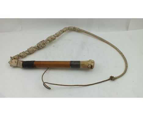 A BEAGLE WHIP, with carved bone hounds head whistle terminal to the malacca cane shaft 