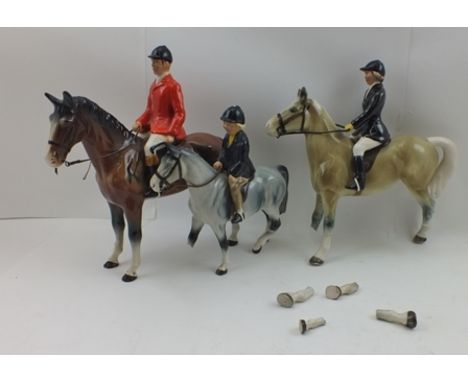 THREE POTTERY HORSE RIDING FIGURINES, includes a Huntsman in hunting pink jacket, 26cm high 
