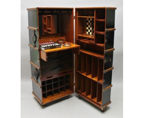 A NOVELTY STEAMER TRUNK COCKTAIL BAR/GAMES CABINET modelled as a banded steamer trunk with leather handles, brass mounted, se