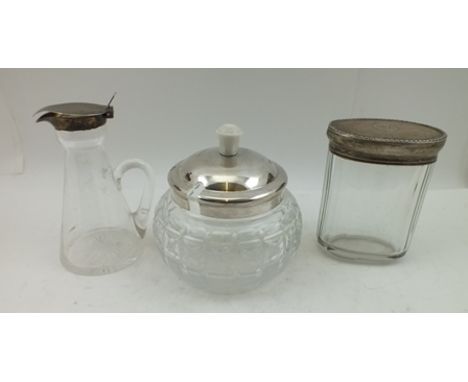 THREE SILVER MOUNTED GLASS ITEMS; an Art Deco conserve jar, the silver cover with Bakelite knop handle, cut glass body, hallm