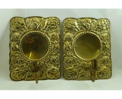A PAIR OF DUTCH DESIGN EMBOSSED BRASS WALL SCONCES with reflector panel backs, panel size 38cm x 31cm 