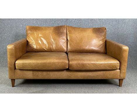 A contemporary retro styled John Lewis sofa in light tan leather upholstery. H.90 W.172 D.105cm 