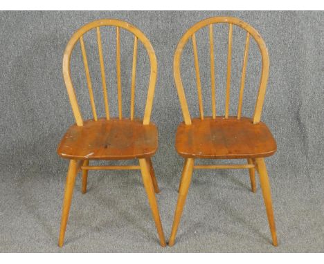 A pair of Ercol model 400 beech and elm stick back chairs. 