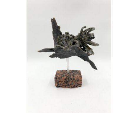 A ceramic figure of a horse in flight raised on a stone base. H.24 W.27cm 