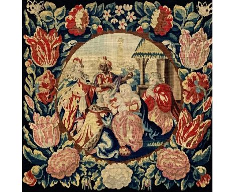 A framed tapestry panel depicting The Nativity with floral border. H.66 W.66cm 