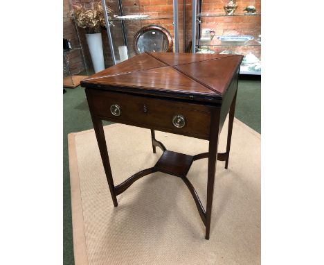 AN EDWARDIAN MAHOGANY ENVELOPE OPENING CARD OR GAMES TABLE, THE FOUR FLAP TOP OPENING TO REVEAL A BAIZE LINED PLAYING SURFACE