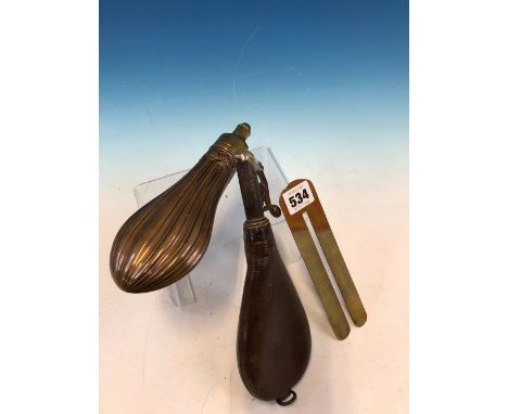 A COPPER POWDER FLASK, A LEATHER SHOT FLASK AND A BRASS CLOTHES GUARD/ BUTTON POLISHER.