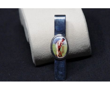 A silver money clip with enamel plaque depicting a cricketer at the crease. Stamped Sterling 925.