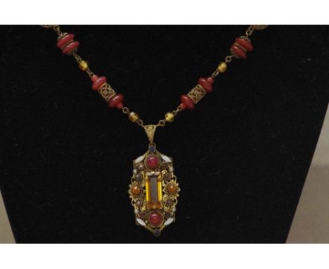 A 1920s vintage Indian pendant necklace set with glass, enamel and wire work decoration.