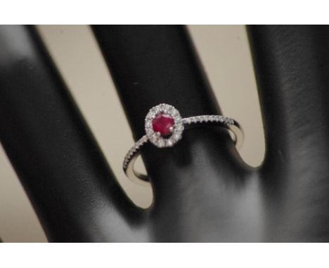 An 18ct white gold, ruby and diamond dress ring. Approximate weight 2.1 grams. Size N.