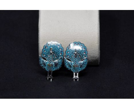 A pair of silver and enamel chip earrings in the form of peacocks.