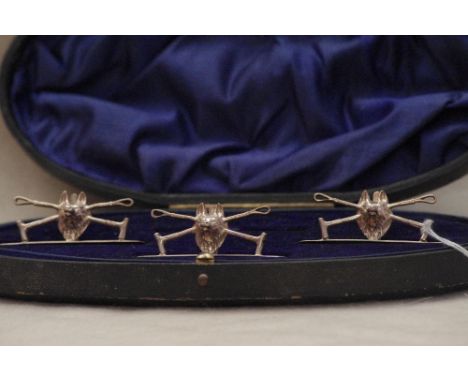 A cased set of three fine silver place name stands in the form of a fox head with crossed riding crops, maker W. HUTTON & SON